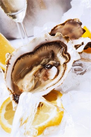 raw oyster - Oysters with lemons on ice, glass of Sekt Stock Photo - Premium Royalty-Free, Code: 659-01846516
