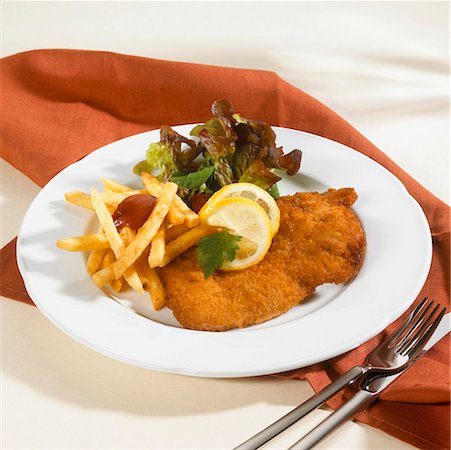 simsearch:659-03528204,k - Wiener Schnitzel with chips, ketchup and salad Stock Photo - Premium Royalty-Free, Code: 659-01846589
