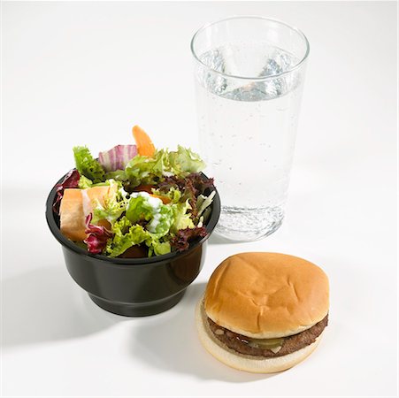snacks and salads recipes - Hamburger, salad and glass of mineral water Stock Photo - Premium Royalty-Free, Code: 659-01846608