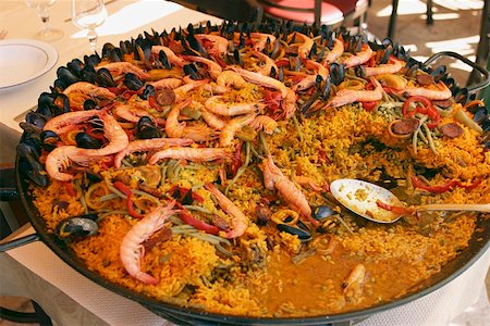 rice pan - Paella in large frying pan on table in restaurant Stock Photo - Premium Royalty-Free, Code: 659-01846620