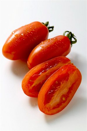 Three 'date' tomatoes, one halved Stock Photo - Premium Royalty-Free, Code: 659-01846795