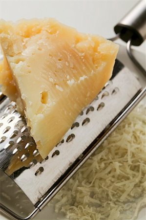 shredded - Piece of Pecorino with grater (close-up) Stock Photo - Premium Royalty-Free, Code: 659-01847186