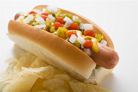 sausage, bun - Hot dog with relish, mustard, ketchup, onions and crisps Stock Photo - Premium Royalty-Free, Code: 659-01847327