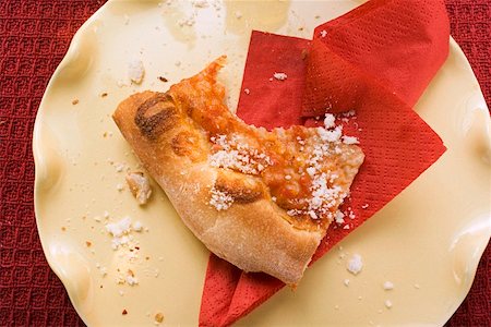 Piece of Pizza Margherita, a bite taken, sprinkled with Parmesan Stock Photo - Premium Royalty-Free, Code: 659-01847603