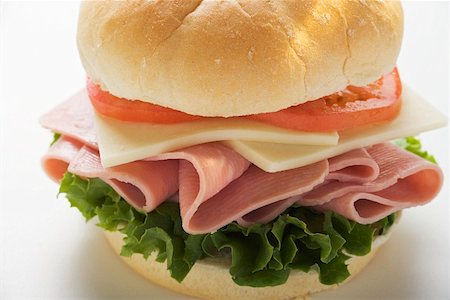 Ham, cheese and tomato in kaiser roll Stock Photo - Premium Royalty-Free, Code: 659-01847709