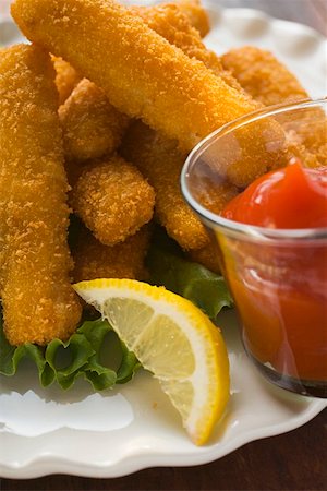 fish sticks - Fish fingers with lemon and ketchup Stock Photo - Premium Royalty-Free, Code: 659-01847787