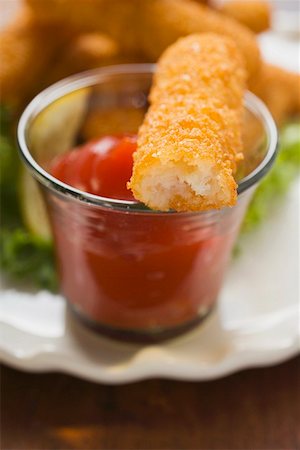 fish sticks - Fish finger with ketchup (a bite taken) Stock Photo - Premium Royalty-Free, Code: 659-01847793