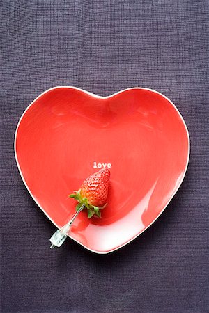 Strawberry on skewer on red heart shaped plate Stock Photo - Premium Royalty-Free, Code: 659-01847821