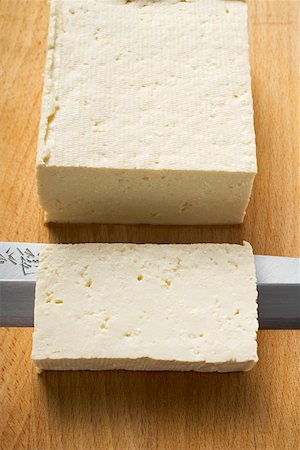 soya product - Block of tofu with a slice cut off Stock Photo - Premium Royalty-Free, Code: 659-01847864