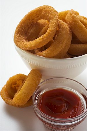 deep fried - Deep-fried onion rings in white bowl, ketchup Stock Photo - Premium Royalty-Free, Code: 659-01847901