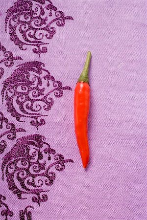 peperoncino - A red chili pepper on purple cloth Stock Photo - Premium Royalty-Free, Code: 659-01848187