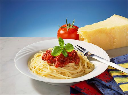 spaghetti - Spaghetti bolognese, tomato and Parmesan behind Stock Photo - Premium Royalty-Free, Code: 659-01848371