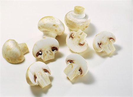 White button mushrooms, whole and halved caps Stock Photo - Premium Royalty-Free, Code: 659-01848458