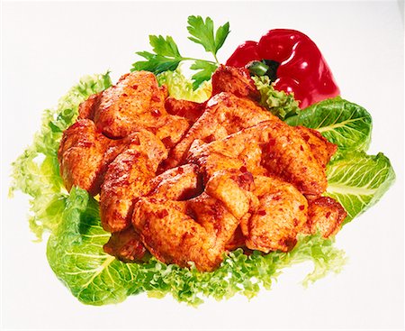 Raw, seasoned chicken piece on lettuce leaves Stock Photo - Premium Royalty-Free, Code: 659-01848484