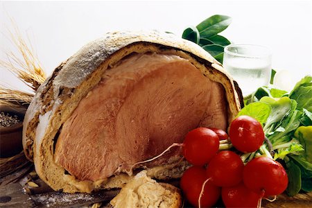 roasted ham - Ham baked in bread dough, a bunch of radishes in front Stock Photo - Premium Royalty-Free, Code: 659-01848558