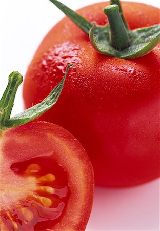 Tomato, whole and halved, with drops of water Stock Photo - Premium Royalty-Free, Code: 659-01848658