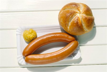 Two Wieners on a Paper Plate with a Dollop of Mustard, Roll Stock Photo - Premium Royalty-Free, Code: 659-01848676