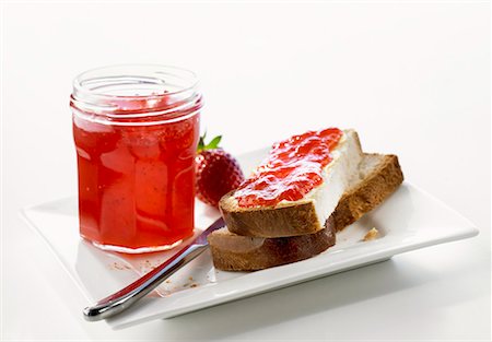 soft fruit conserve - Strawberry jam in jar & on Blatz (sweet yeasted white bread) Stock Photo - Premium Royalty-Free, Code: 659-01849018
