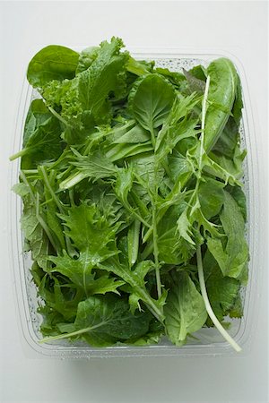 salad greens on white background - Spinach and Japanese mizuna in plastic container Stock Photo - Premium Royalty-Free, Code: 659-01849641