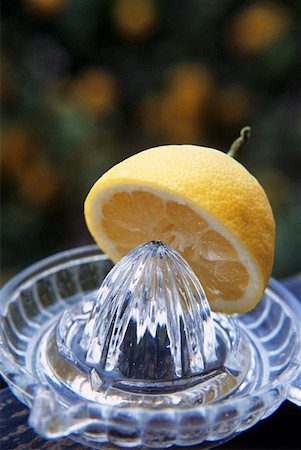 squeeze lemon - Lemon half with lemon squeezer Stock Photo - Premium Royalty-Free, Code: 659-01849799