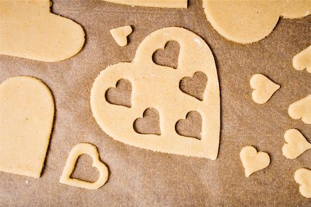 simsearch:659-03536702,k - Cut-out heart-shaped biscuits on baking parchment Stock Photo - Premium Royalty-Free, Code: 659-01849906