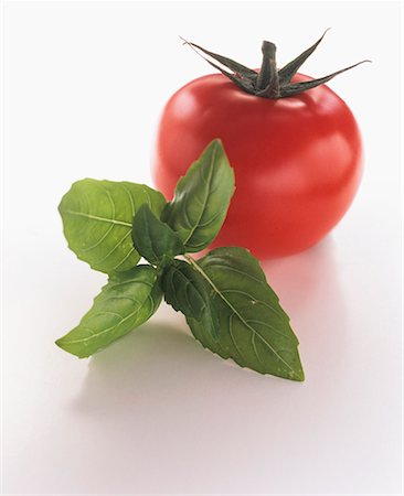 simsearch:659-03529233,k - A Tomato with a Sprig of Basil Stock Photo - Premium Royalty-Free, Code: 659-01842339