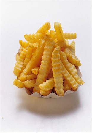 fatty - Crinkle Cut French Fries in a Carton Stock Photo - Premium Royalty-Free, Code: 659-01842464