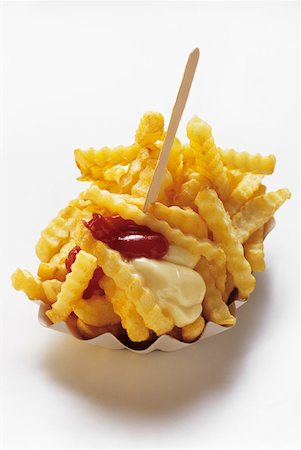 simsearch:659-03531074,k - Crinkle Cut French Fries in a Carton with Ketchup and Mayonnaise Stock Photo - Premium Royalty-Free, Code: 659-01842463