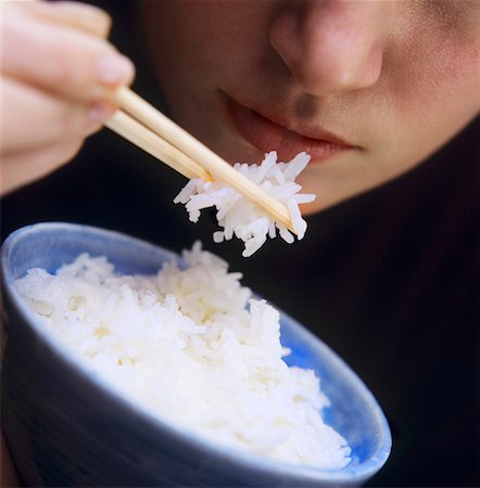 A Person Eating Rice with Chopsticks Stock Photo - Premium Royalty-Free, Code: 659-01842746