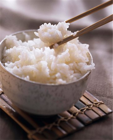 rice on chopstick - A Bowl of Cooked Rice with Chopsticks Stock Photo - Premium Royalty-Free, Code: 659-01842748