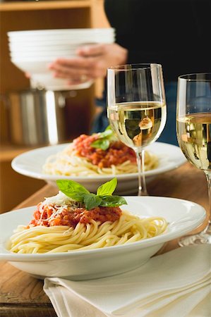 Spaghetti bolognese and white wine for two on table Stock Photo - Premium Royalty-Free, Code: 659-01842878