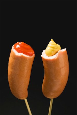 Sausages with ketchup & mustard on wooden cocktail sticks Stock Photo - Premium Royalty-Free, Code: 659-01842943