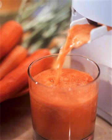 Carrot juice running out of a juicer Foto de stock - Royalty Free Premium, Número: 659-01842994