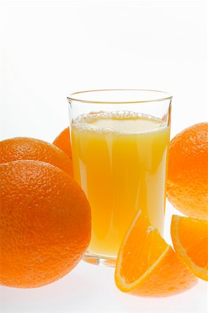 simsearch:659-06153064,k - Orange juice in glass among oranges Stock Photo - Premium Royalty-Free, Code: 659-01843067