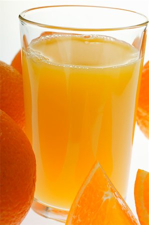 simsearch:659-08147293,k - Orange juice in glass among oranges (close-up) Stock Photo - Premium Royalty-Free, Code: 659-01843068
