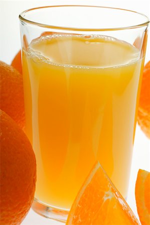 simsearch:659-01864210,k - Orange juice in glass among oranges (close-up) Foto de stock - Sin royalties Premium, Código: 659-01843068