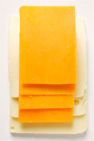 Cheese slices: Extra Sharp Cheddar on American cheese Stock Photo - Premium Royalty-Free, Code: 659-01843168