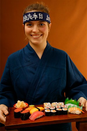 Woman serving sushi platter Stock Photo - Premium Royalty-Free, Code: 659-01843281