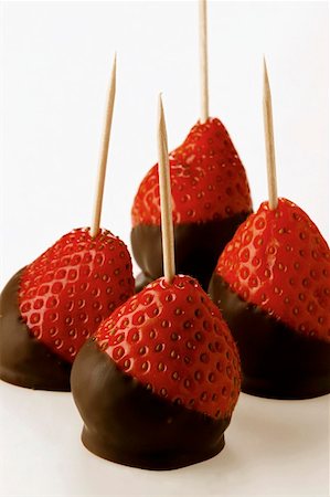 Chocolate-coated strawberries on toothpicks Stock Photo - Premium Royalty-Free, Code: 659-01843346