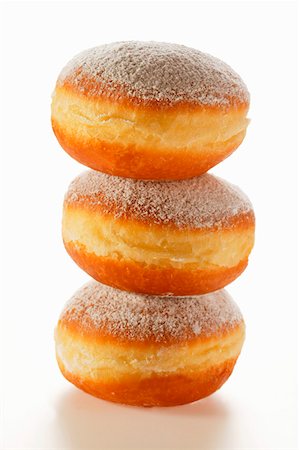 Doughnuts with icing sugar, in a pile Stock Photo - Premium Royalty-Free, Code: 659-01843533