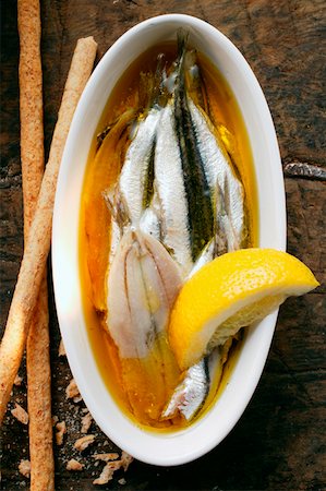 fish with olive oil - Marinated sardines with lemon and grissini Stock Photo - Premium Royalty-Free, Code: 659-01843741