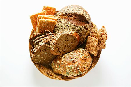 sliced brown bread - Various types of wholemeal bread & crispbread in bread basket Stock Photo - Premium Royalty-Free, Code: 659-01843796