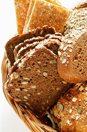 sliced brown bread - Various types of wholemeal bread & crispbread in bread basket Stock Photo - Premium Royalty-Free, Code: 659-01843797