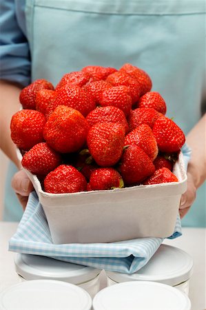 simsearch:659-01864546,k - Woman holding punnet of strawberries, jam jars Stock Photo - Premium Royalty-Free, Code: 659-01843970