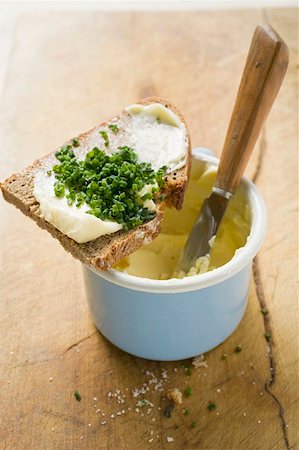 Bread and chives on a butter pot Stock Photo - Premium Royalty-Free, Code: 659-01854075