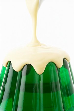 Pouring custard over woodruff jelly Stock Photo - Premium Royalty-Free, Code: 659-01854584