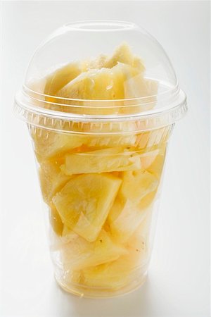 Pineapple chunks in a plastic cup with a lid Stock Photo - Premium Royalty-Free, Code: 659-01854724