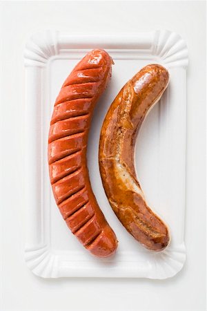 White and red sausages on a paper plate Stock Photo - Premium Royalty-Free, Code: 659-01854725