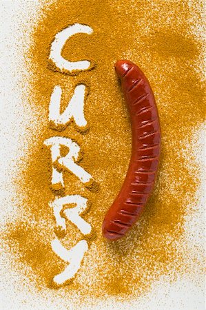A sausage on curry powder Stock Photo - Premium Royalty-Free, Code: 659-01854761