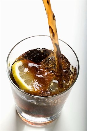 Pouring cola into a glass Stock Photo - Premium Royalty-Free, Code: 659-01854800